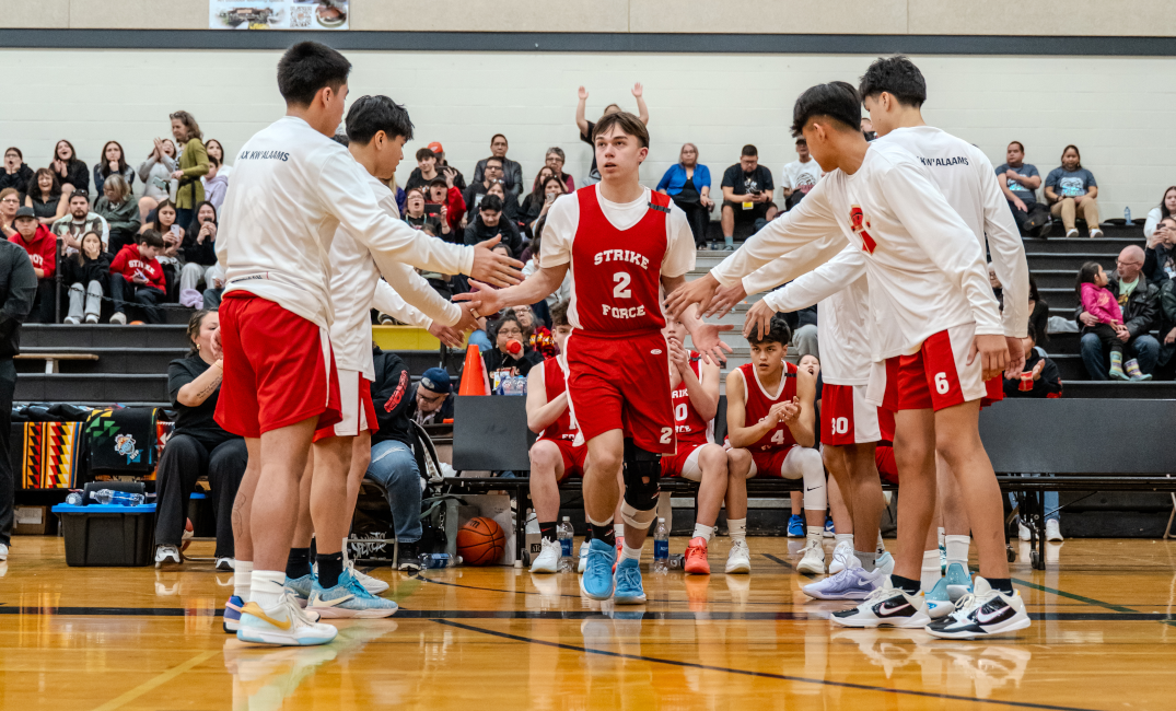 A photo of a basketball team during player introductions